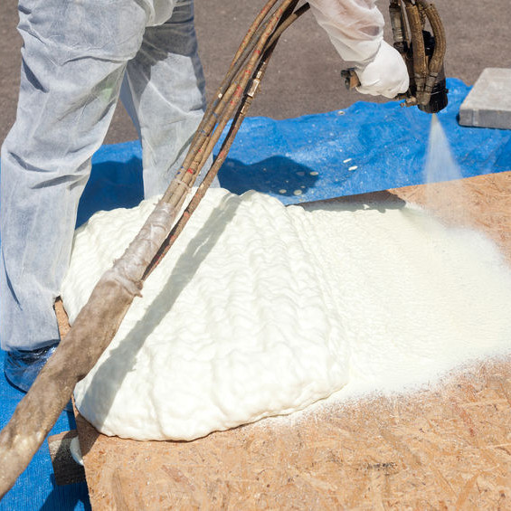 A Man Applying Spray Foam Roofing.