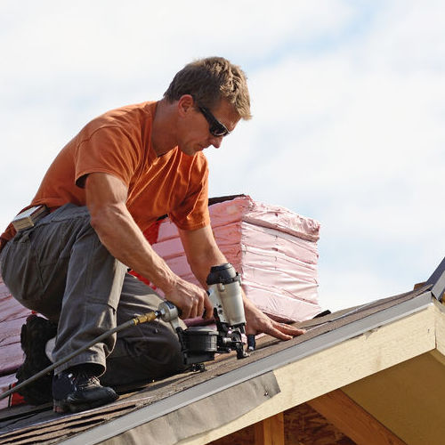 A Roofer Works on a Roof.