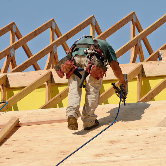 A Roofer With a Nail Gun.