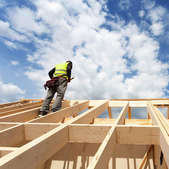 A Single Roofer on an Unfinished Roof.