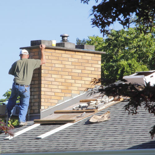 A Roofer Repairs a Roof.