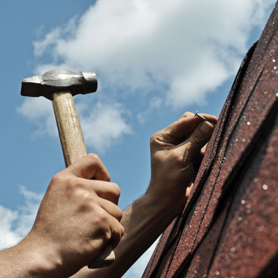 A Roofer Repairs Shingles.