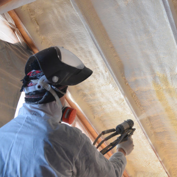 A Man Spraying on Foam Insulation.