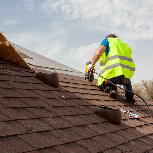 A Roofer Works on a Roof Installation.
