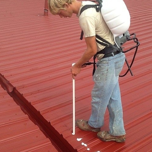 A Roofer Works on a Metal Roof.