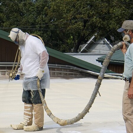 A Roofer Uses Spray Foam.