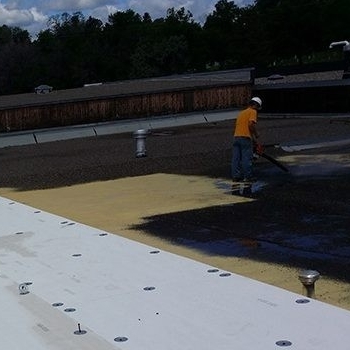 A Roofer Adds a Silicone Roof Coating.