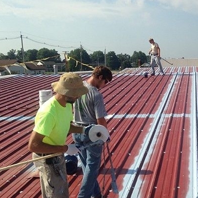 Roofers Working on Metal Roof Restoration.